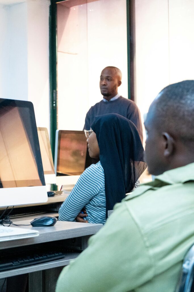 Students engaging in coding at a modern computer lab with a focus on ICT skills.